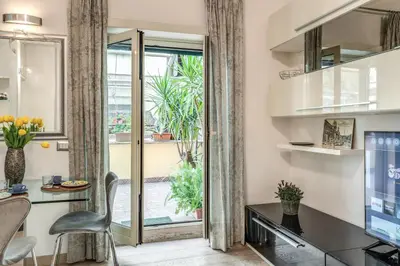a living room with a desk and a window at Santa Croce apartment with private terrace in Rome