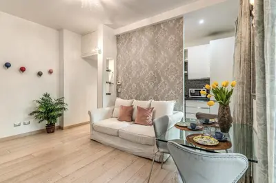 a living room with a couch and a table at Santa Croce apartment with private terrace in Rome