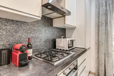 a kitchen with a stove top oven next to a microwave at Santa Croce apartment with private terrace in Rome