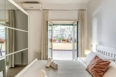 a bedroom with a bed with shoes on it at Santa Croce apartment with private terrace in Rome