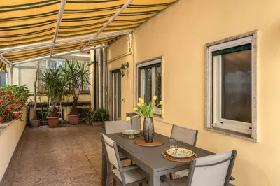 a table and chairs on a patio with a table at Santa Croce apartment with private terrace in Rome