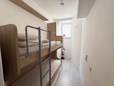 a small room with two bunk beds in it at Valerias Nest Elegant Apt with WiFi and Charm in Rome