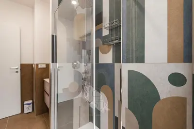 a shower with a glass door in a bathroom at Prestige Bellavista Apartment in Rome