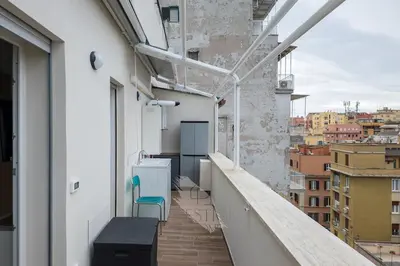 a balcony with a blue chair on a building at Prestige Bellavista Apartment in Rome