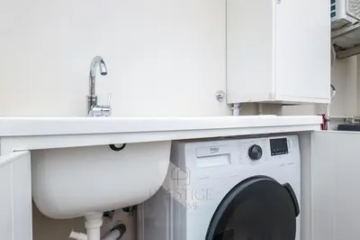 a sink and a washing machine under a counter at Prestige Bellavista Apartment in Rome