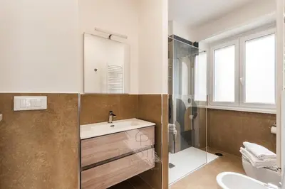 a bathroom with a sink and a shower and a toilet at Prestige Bellavista Apartment in Rome