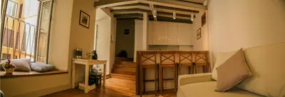 a living room with a couch and a kitchen at Casa Di Armando al Pantheon in Rome