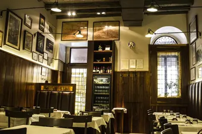 a dining room with tables and chairs and a window at Casa Di Armando al Pantheon in Rome