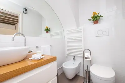 a white bathroom with a sink and a toilet at Casa Di Armando al Pantheon in Rome
