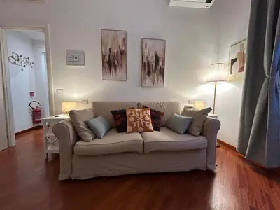 a living room with a couch with pillows on it at Domus Vittoria in Rome