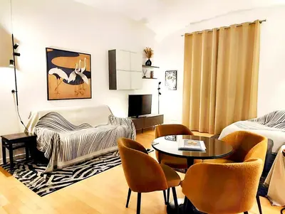 a living room with a bed and a table and chairs at Vatican Best Suite in Rome