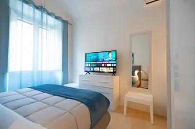 a bedroom with a large bed with a television on it at Vatican Best Suite in Rome