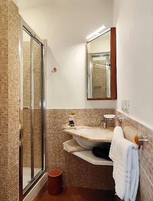 a bathroom with a toilet and a sink and towels at Vatican Best Suite in Rome