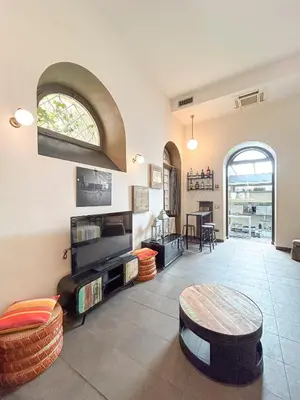a living room with a table and a couch at Domus Loft Colosseum - Rione Monti in Rome