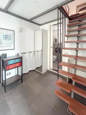 a bathroom with a staircase and a toilet at Domus Loft Colosseum - Rione Monti in Rome