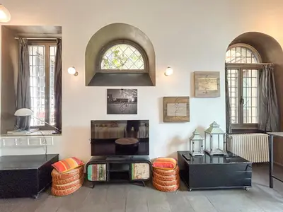 a room with two windows and two tables and chairs at Domus Loft Colosseum - Rione Monti in Rome