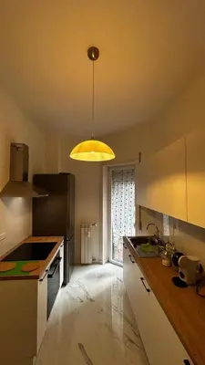 a kitchen with a light hanging from a ceiling at Bella Roma Stay in Rome
