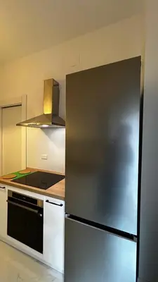 a kitchen with a stainless steel refrigerator at Bella Roma Stay in Rome