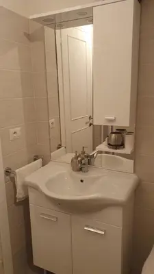 a white bathroom with a sink and a mirror at Bella Roma Stay in Rome