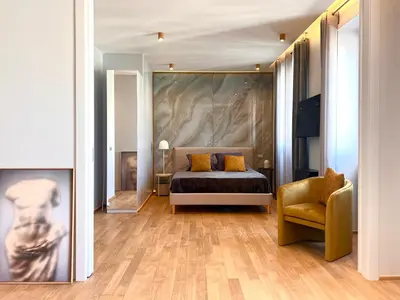 a bedroom with a bed and a painting on the wall at Luxury Suite Monti Quirinale in Rome