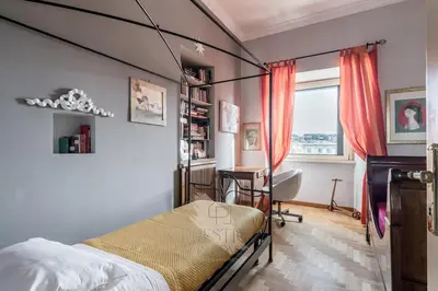 a bedroom with a bed and a desk and a window at New! Una Finestra su San Pietro in Rome
