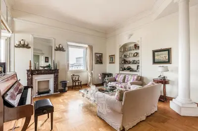 a living room with a couch and a piano at New! Una Finestra su San Pietro in Rome