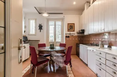 a kitchen with a table and chairs in a kitchen at New! Una Finestra su San Pietro in Rome
