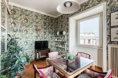 a dining room with a table and chairs at New! Una Finestra su San Pietro in Rome