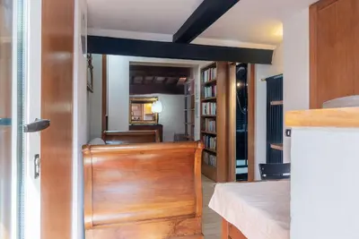 a room with a wooden door and bookshelves at Orange Room with bathroom and Shared Terrace in Rome