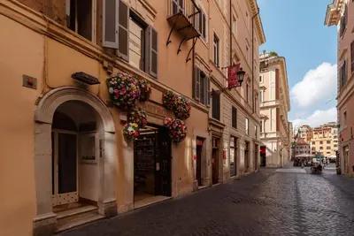 an alley with flowers on the side of a building at Orange Room with bathroom and Shared Terrace in Rome