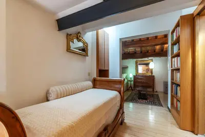 a bedroom with a bed and a dresser at Orange Room with bathroom and Shared Terrace in Rome