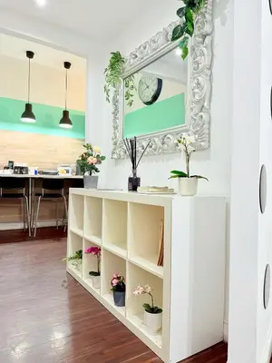 a white cabinet with potted plants on it in a room at Turati maison d'hotes in Rome