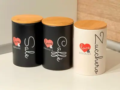 three black and white tubes sitting on a shelf at Turati maison d'hotes in Rome