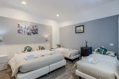 a room with two beds and a tv in it at Turati maison d'hotes in Rome