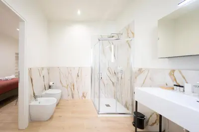a bathroom with a shower and a toilet and a sink at Domus Giulio Guest House in Rome