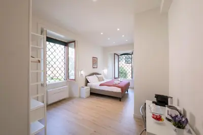 a bedroom with a bed and a room with a window at Domus Giulio Guest House in Rome