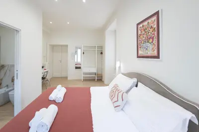 a bedroom with a bed with towels on it at Domus Giulio Guest House in Rome