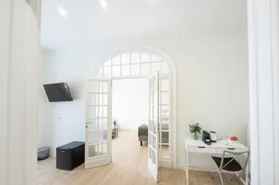 an archway leading into a white room with a desk and a door at Domus Giulio Guest House in Rome
