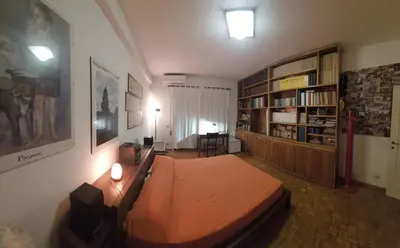 a bedroom with a bed and a book shelf at La Casa Dei Nonni al Vaticano in Rome