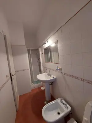 a white bathroom with a sink and a toilet at La Casa Dei Nonni al Vaticano in Rome