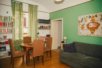 a living room with a table and a couch at La Casetta del '32 in Rome