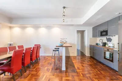 a kitchen and dining room with a table and red chairs at Vatican Pixel Apartments in Rome
