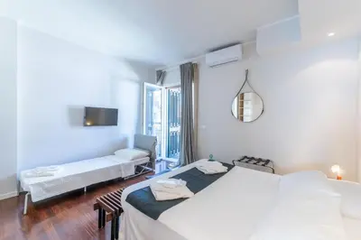 a bedroom with two beds and a couch in it at Vatican Pixel Apartments in Rome