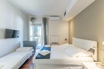 a room with a bed and a couch and a tv at Vatican Pixel Apartments in Rome