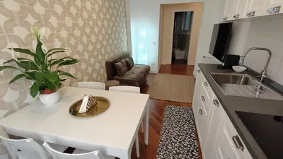 a kitchen with a sink and a table with a plant at La Casa Di Elda - 2 Camere - Metro B in Rome