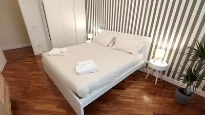 a white bed with two towels on it in a room at La Casa Di Elda - 2 Camere - Metro B in Rome