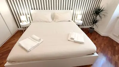 a large white bed with two white towels on it at La Casa Di Elda - 2 Camere - Metro B in Rome