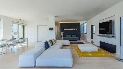 a living room with a white couch and a tv at EasyTopStay - Rome from above Apt with a view in Rome