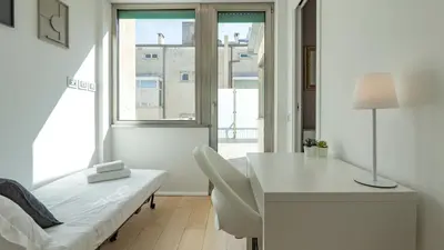 a white room with a desk and a bed and a window at EasyTopStay - Rome from above Apt with a view in Rome