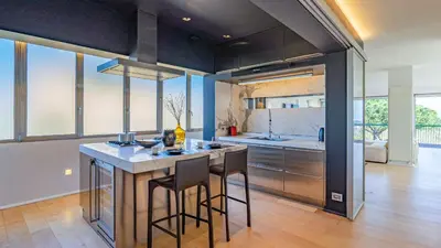 a kitchen with a island in the middle of a room at EasyTopStay - Rome from above Apt with a view in Rome